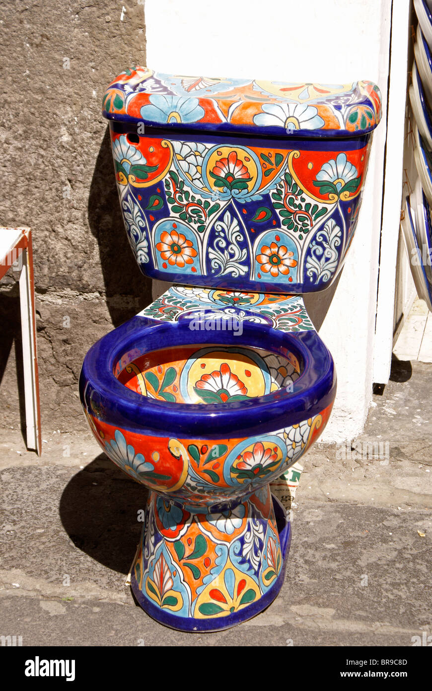 Brightly painted toilet for sale at El Parian handicrafts market in the city of Puebla, Mexico, Mexico. Stock Photo