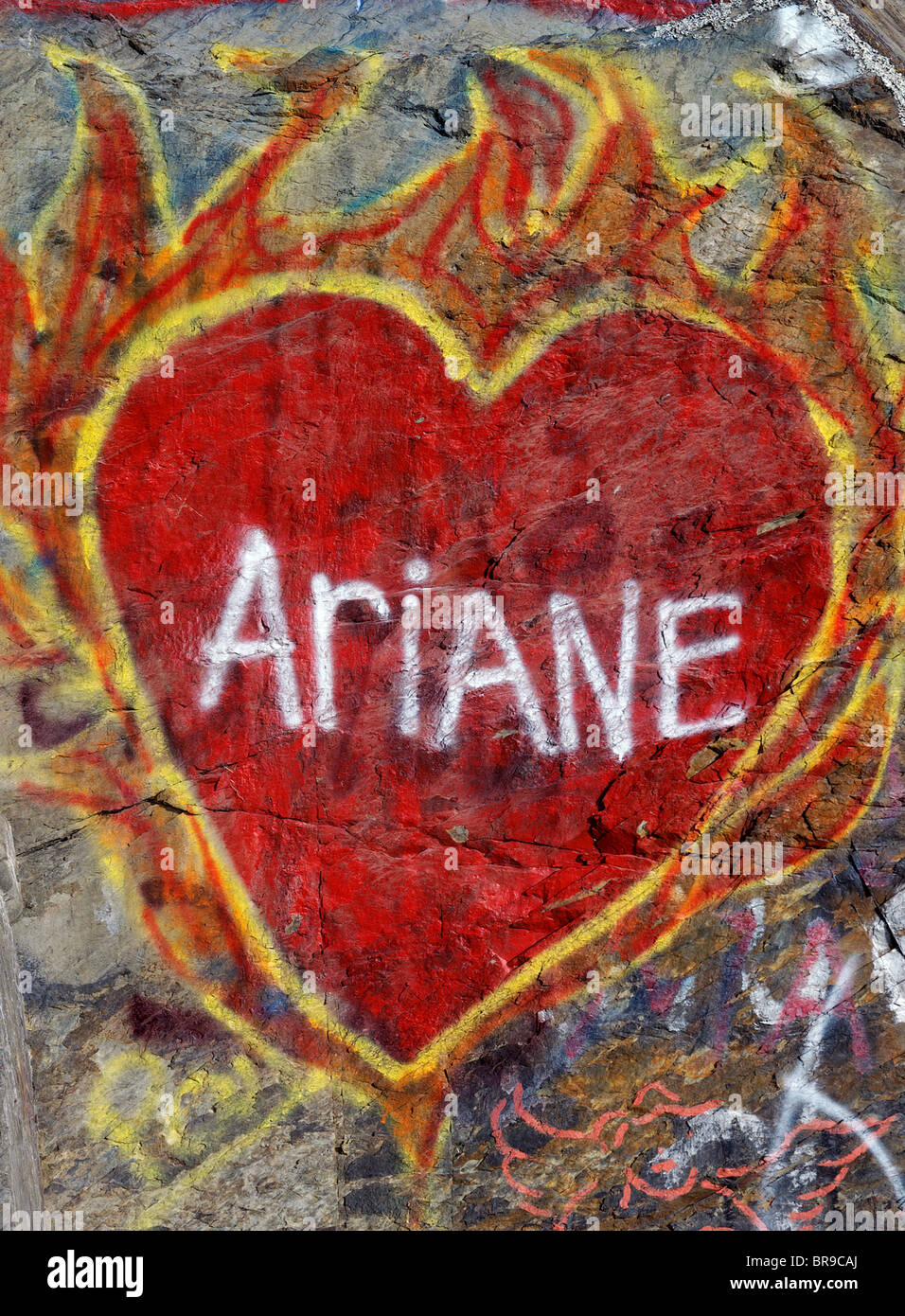 A flaming love heart painted on a wall Stock Photo