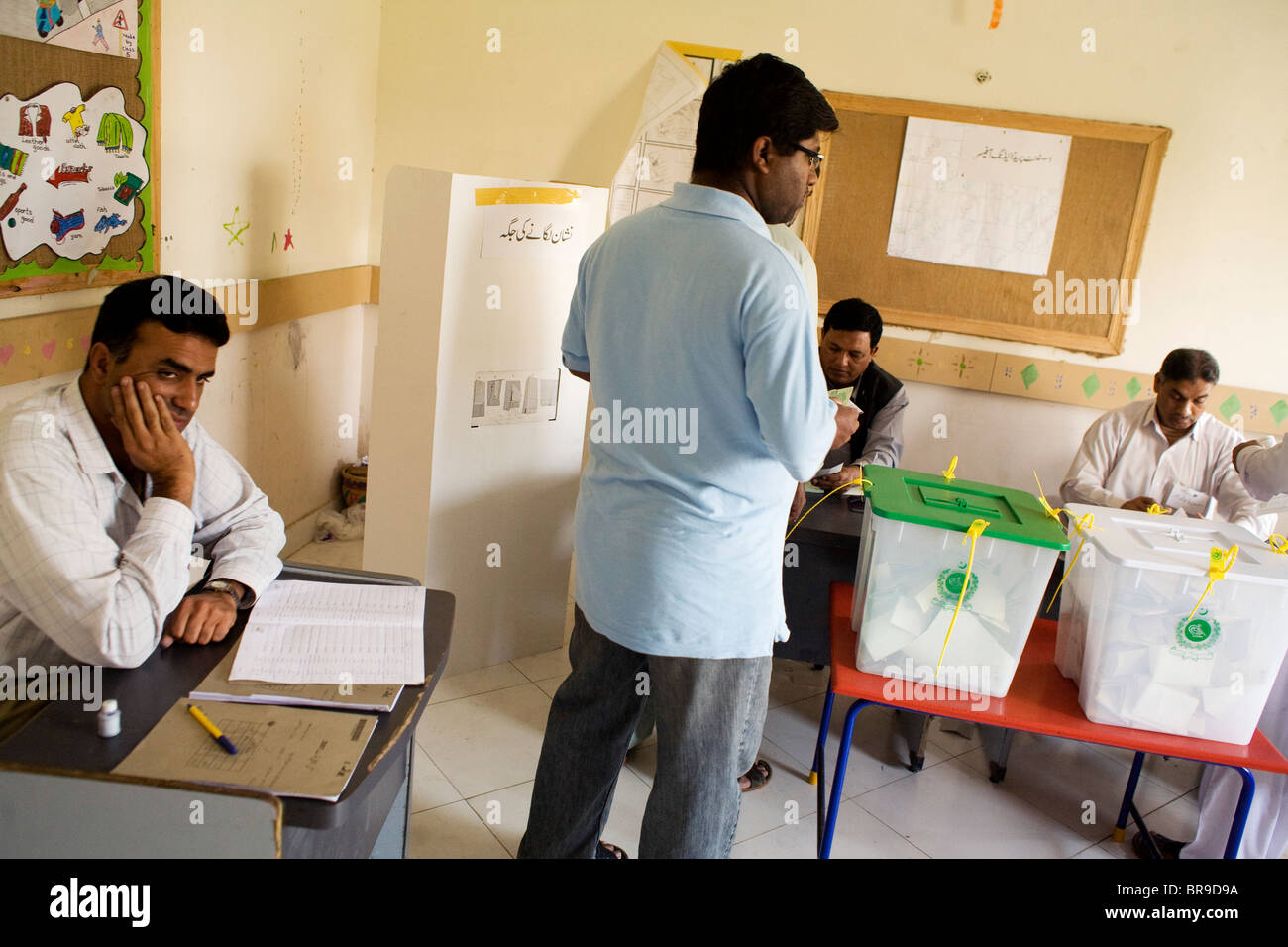 A bored poll worker in Karachi Pakistan. Stock Photo