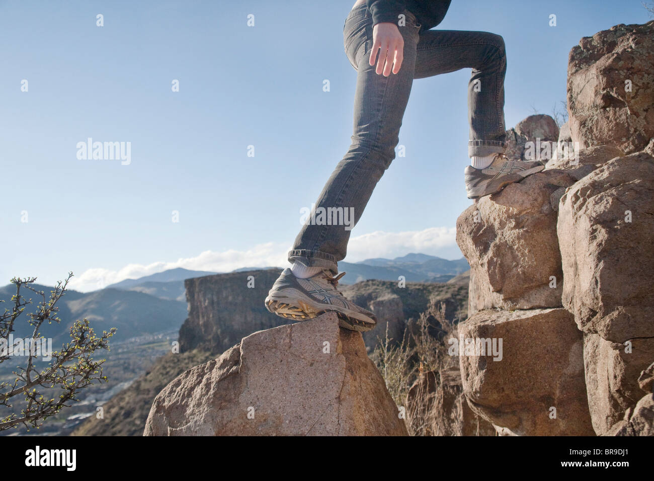 woman climbs rocks Stock Photo