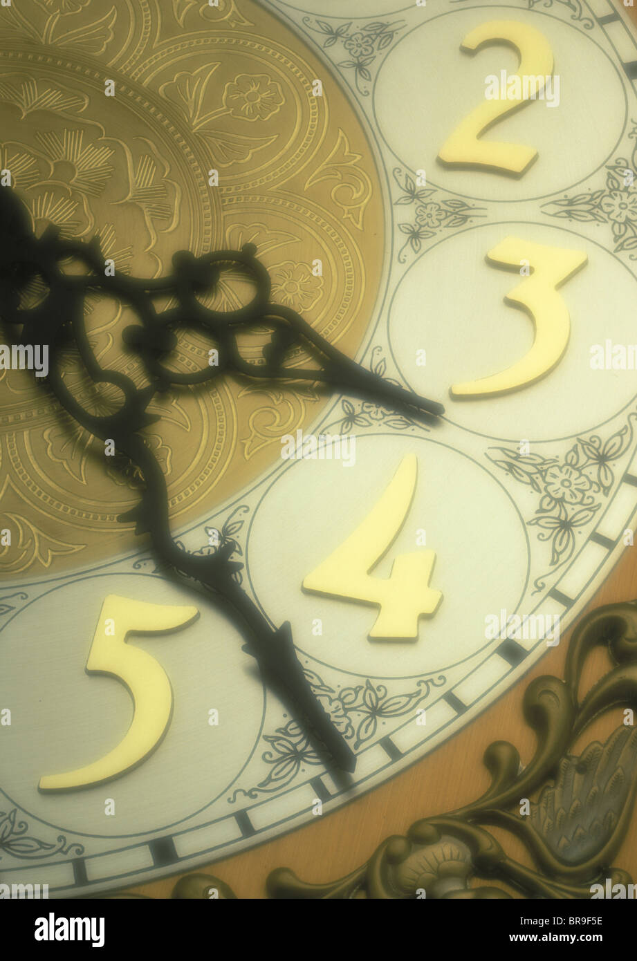 1980s SYMBOLIC HANDS AND FACE OF ANTIQUE CLOCK Stock Photo