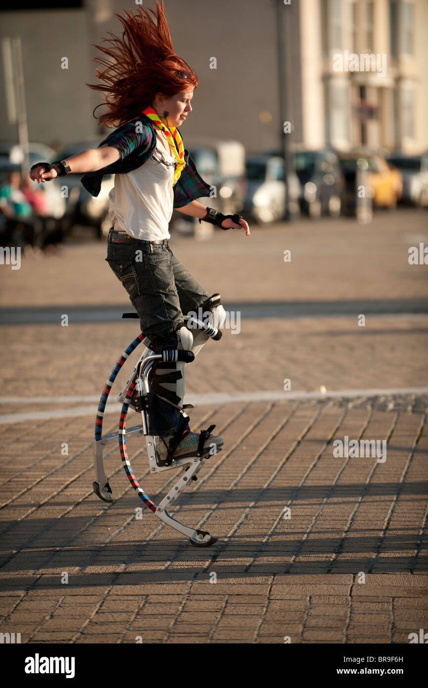 A teenage girl using spring power stilts, UK Stock Photo Alamy