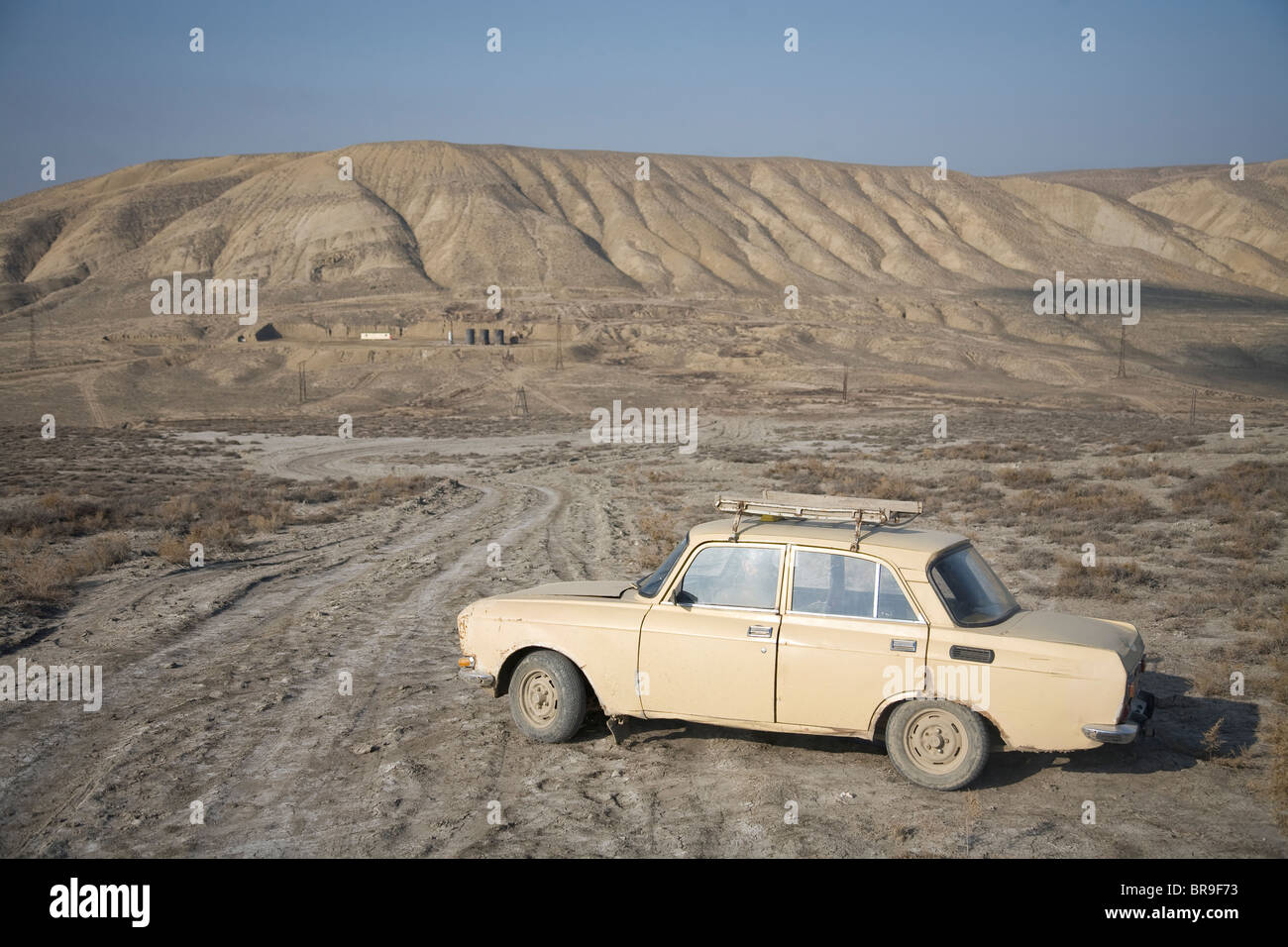 Russia Lada in the barren Azeri landscape near Qobustan Azerbaijan Stock Photo