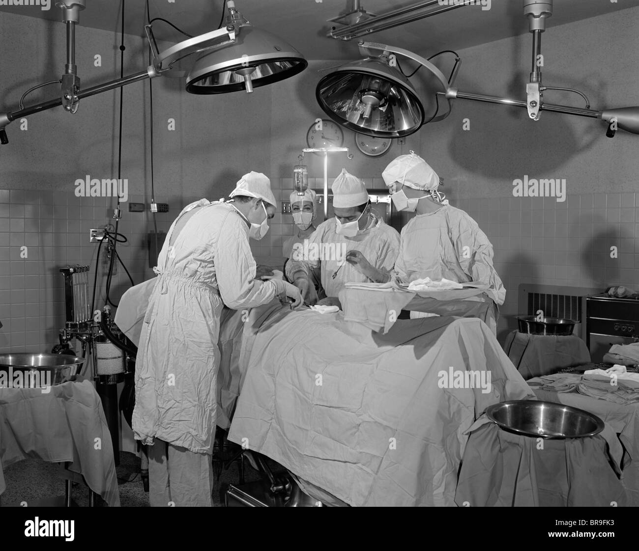 DOCTORS IN OPERATING ROOM OPERATING ON PATIENT Stock Photo