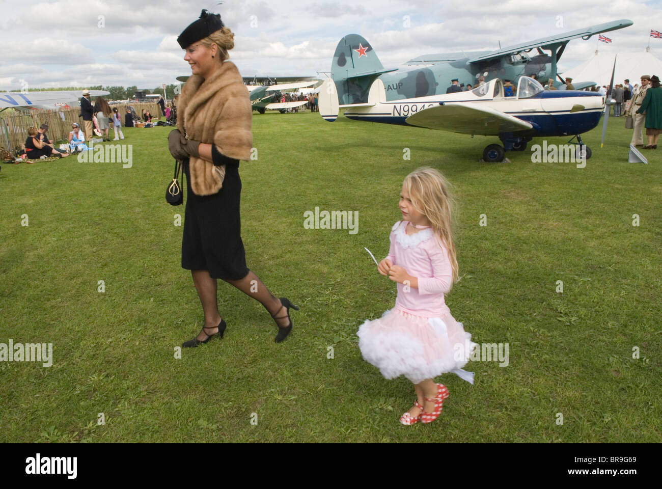 Retro fashion mother and daughter dressing living in the more glamorous fashionable past. Her hobby seen here at the  Revival Weekend at Goodwood Festival of Speed. Goodwood Sussex.  2010 2010s UK. HOMER SYKES Stock Photo