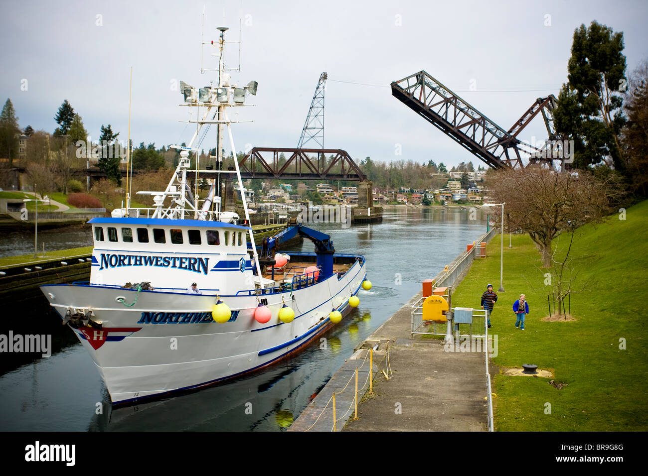 A fishing trawler moves through the Ballard Locks in Seattle Washington. Stock Photo