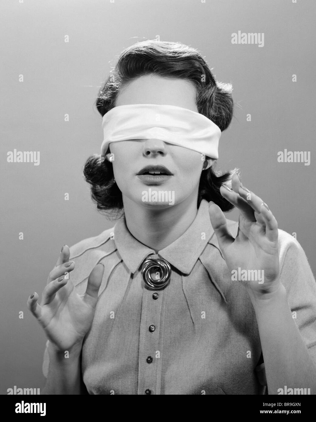 1950s WOMAN BLINDFOLDED Stock Photo