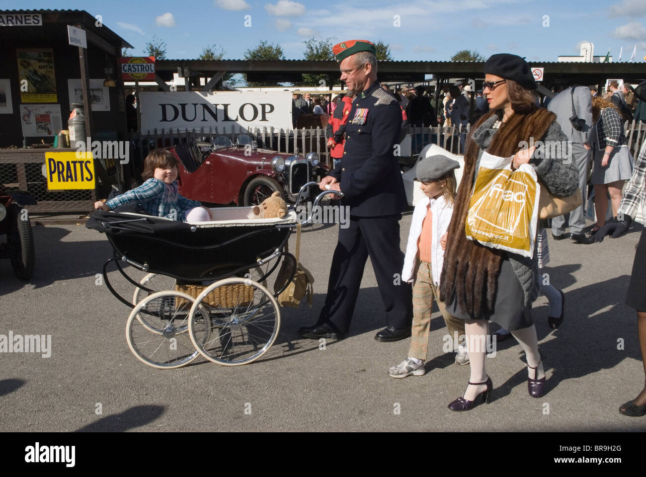 A 1957 vintage Marmet pram with retro family dressed up living inthe past make believe. at the in the style of the 1940s Goodwood Festival of Speed. Goodwood Sussex. UK. 2010 2010s HOMER SYKES Stock Photo