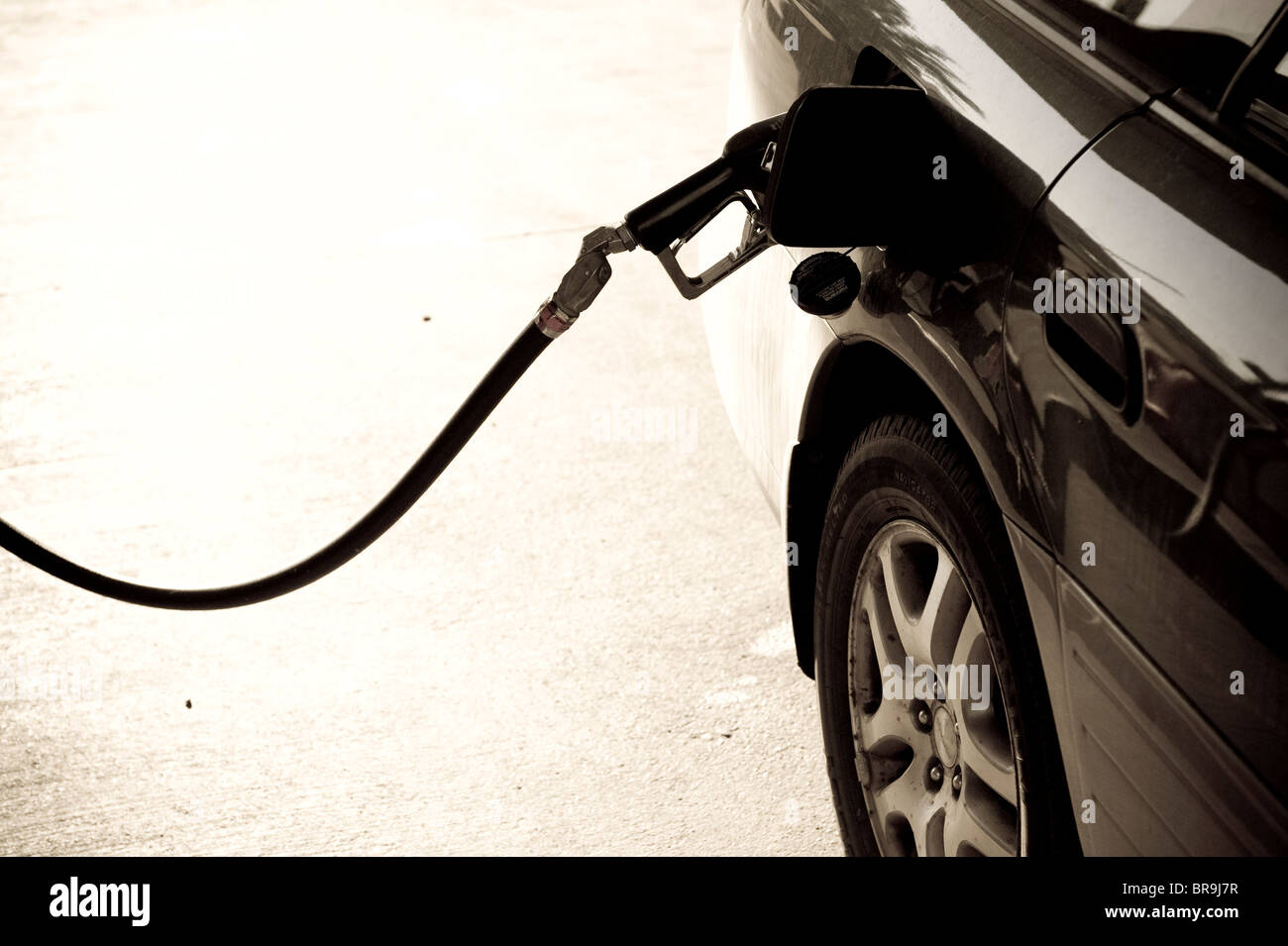 Gas pump nozzle in car gas tank Ontario Oregon. (toned image Stock