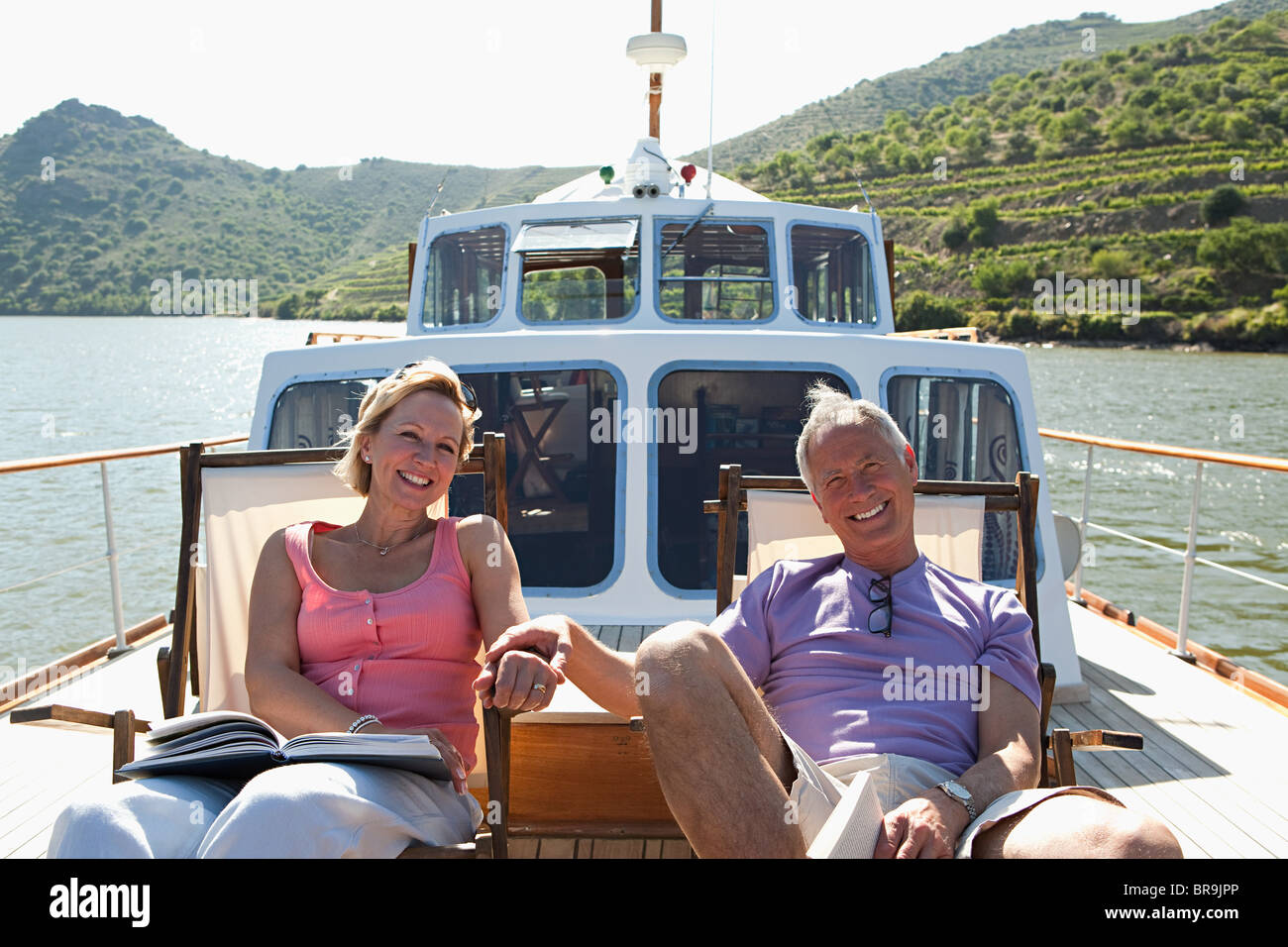 Senior couple sitting on deckchairs on a boat Stock Photo - Alamy
