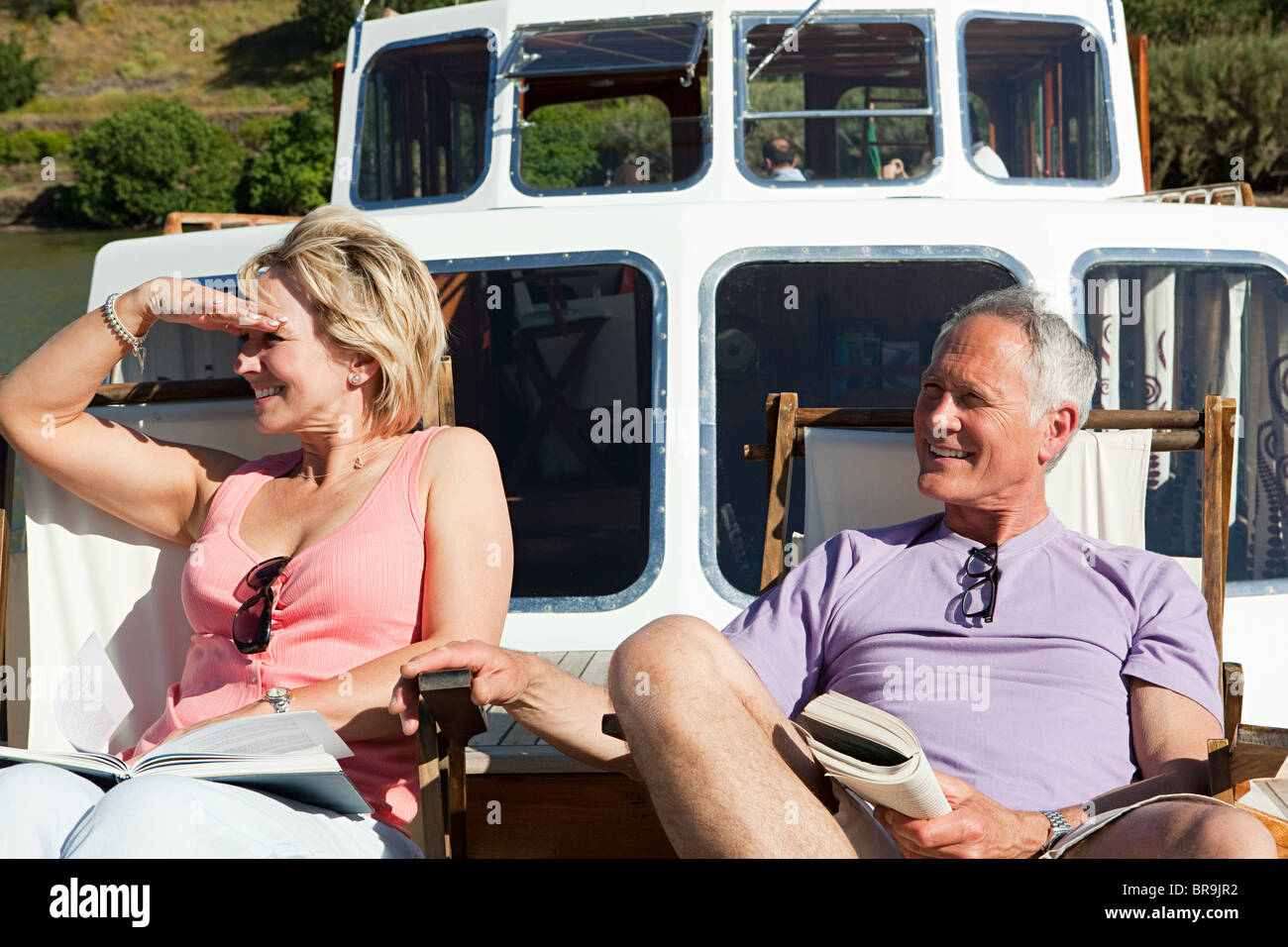Senior couple sitting on deckchairs on a boat Stock Photo - Alamy