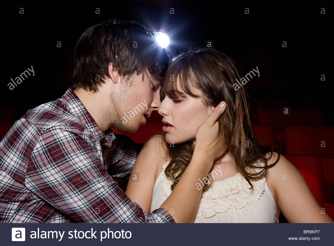 passionate young couple in the movie theater stock photo 31560543