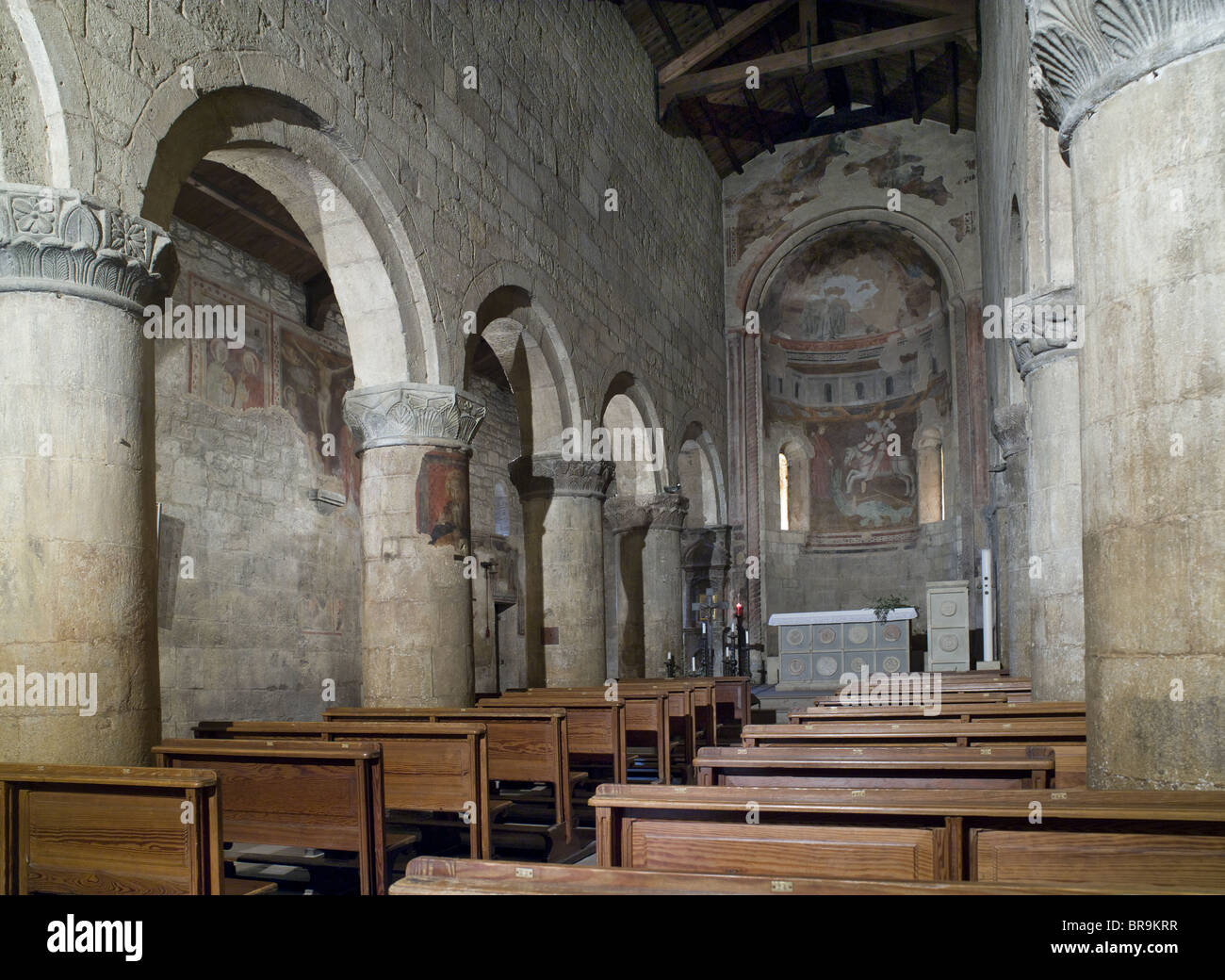 Vigoleno,  Italy. 12th century Church of San Giorgio. Interior nave and apse, with Romanesque columns and round headed arches. Stock Photo