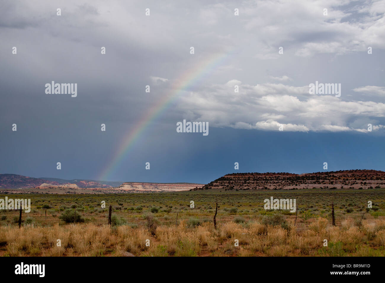 Rainbow emerging from a mesa landscape in the high desert of Utah, USA Stock Photo