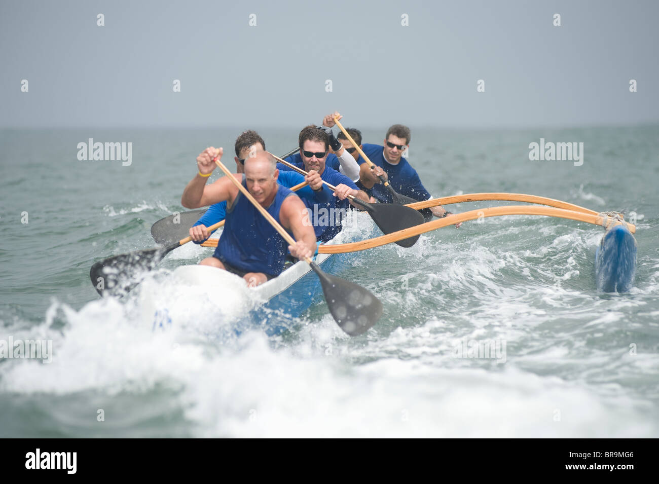 Outrigger canoeing team on water Stock Photo