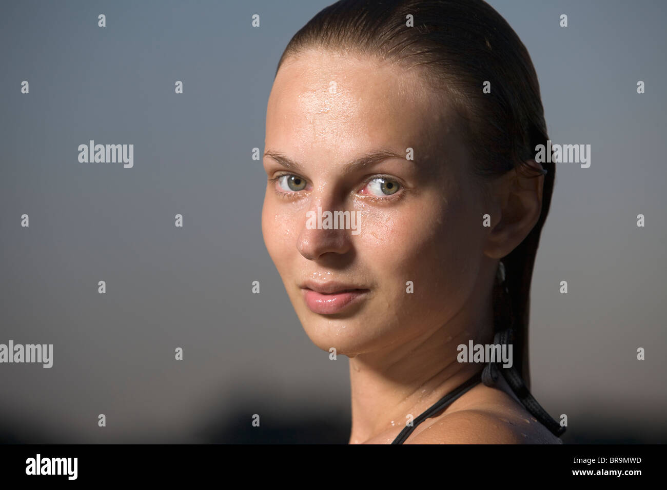 Portrait of young woman in swimming costume at dusk Stock Photo - Alamy