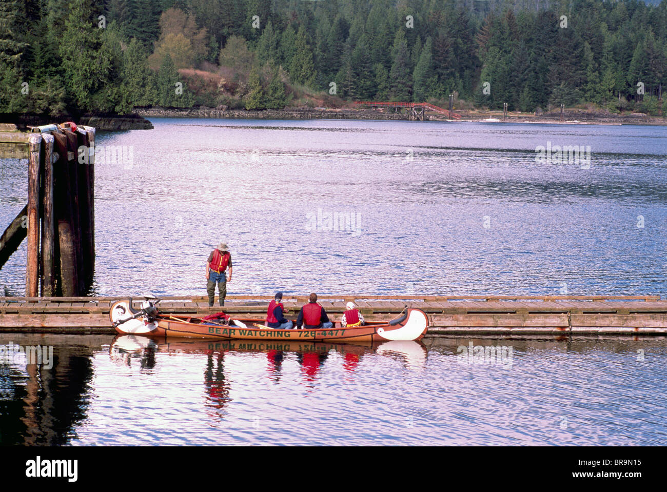 Ucluelet, BC, Vancouver Island, British Columbia, Canada - Tourists leaving on Guided Bear Watching Tour in Canoe Stock Photo