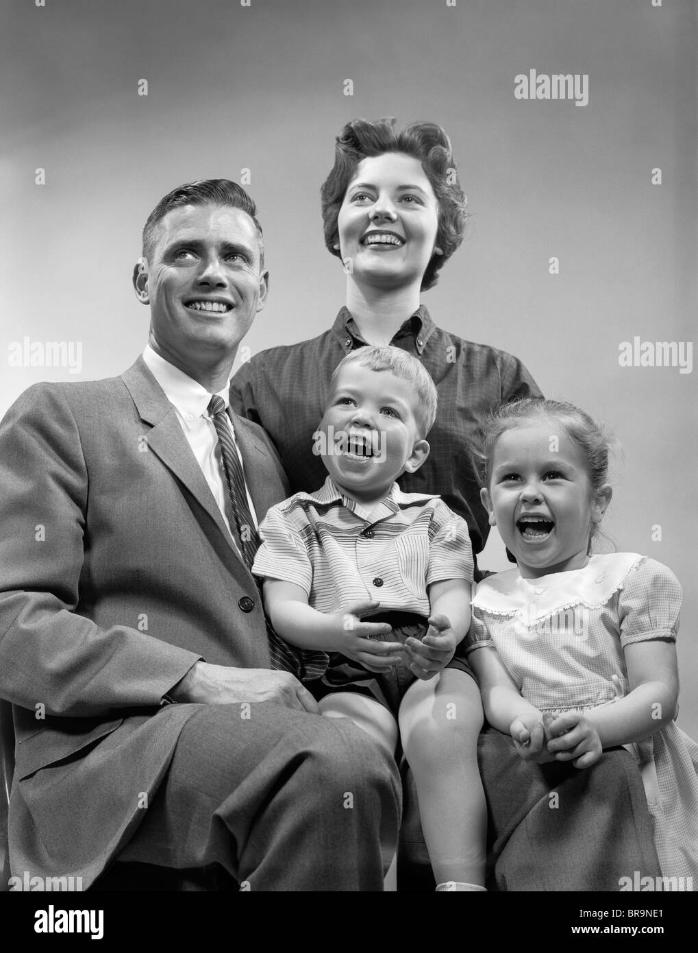 1950s FAMILY SMILING POSING TOGETHER Stock Photo