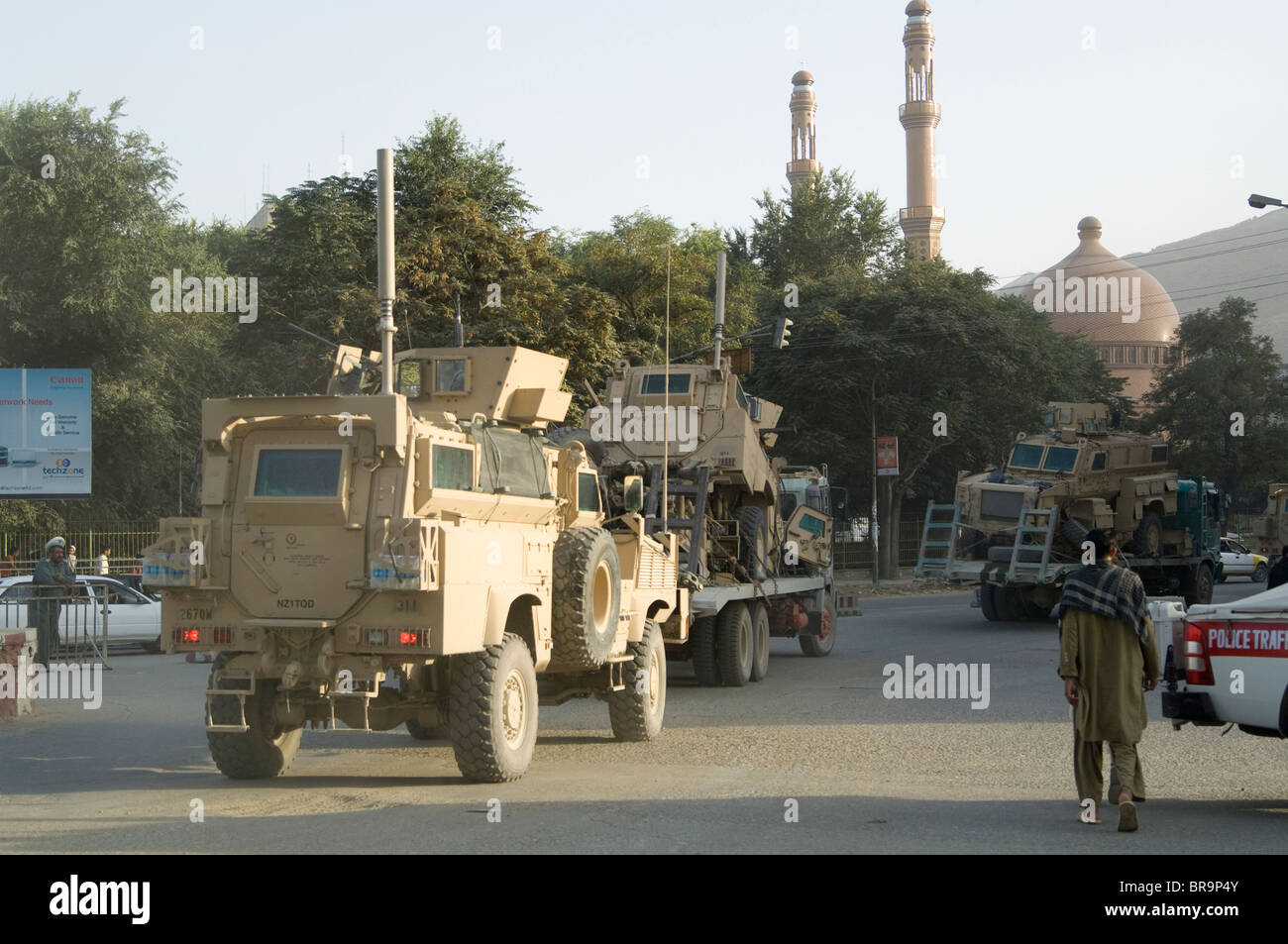 Armored vehicles roll through street in Kabul, Afghanistan after battle Stock Photo