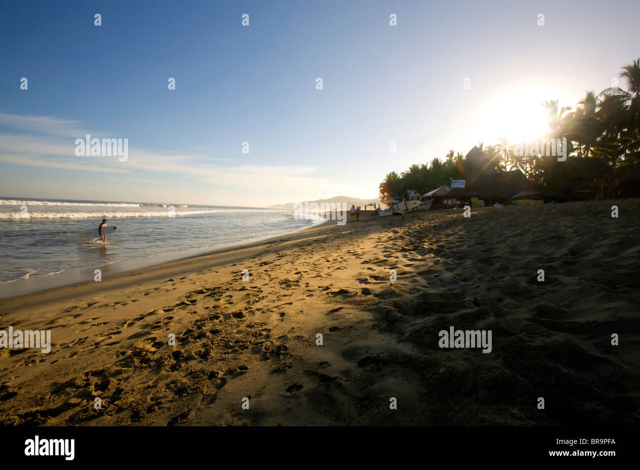 Early morning surfers on the beach in Sayulita Mexico. Stock Photo