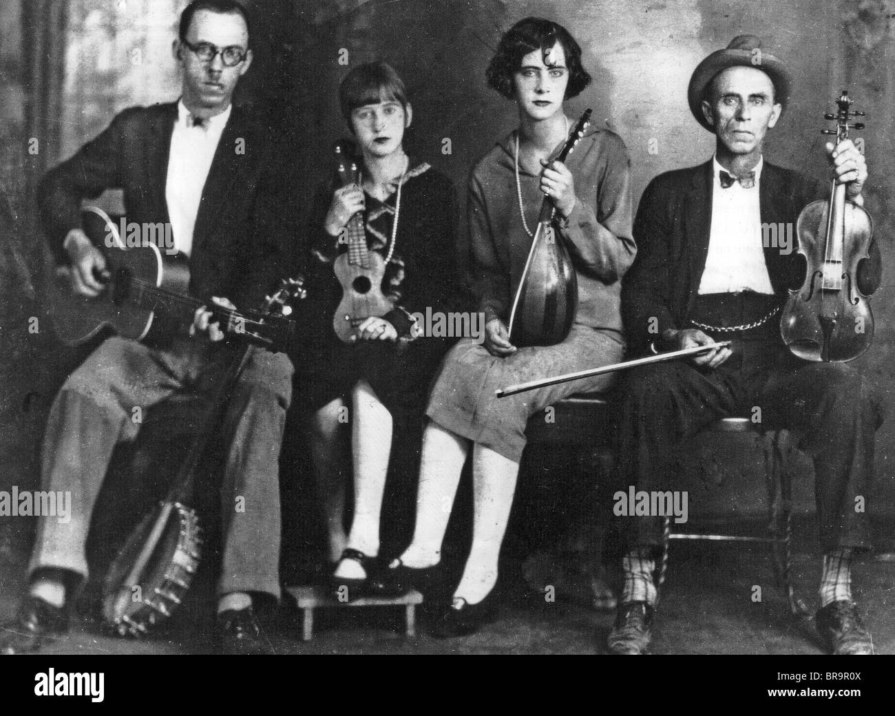 POWERS FAMILY  US Country music group in 1926. From left: Charlie, Ada, Opha Lou, and father Fiddlin'  Cowan Powers. Stock Photo