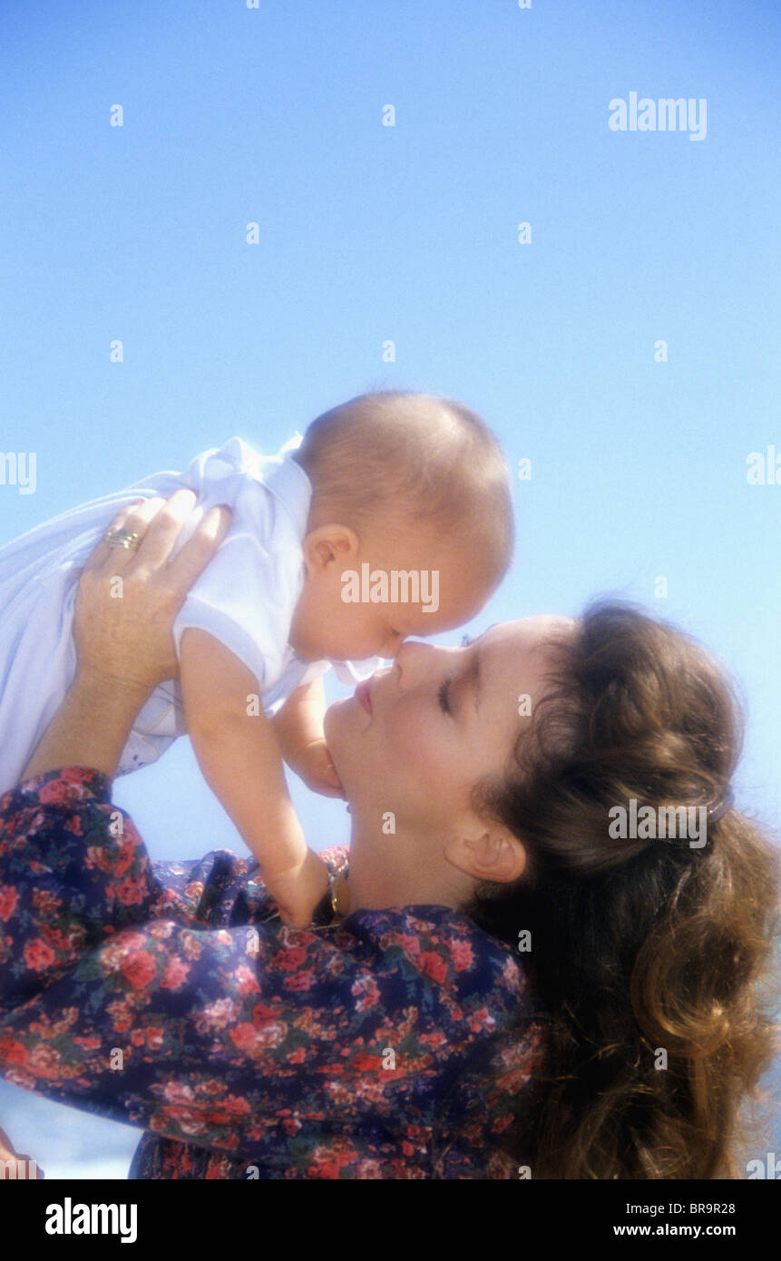 1990s MOTHER PLAYING WITH BABY SON OUTDOORS Stock Photo - Alamy