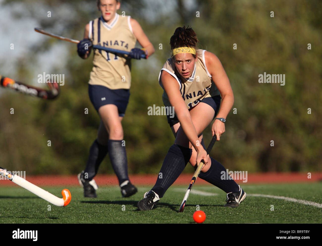 A Juniata College player passes the ball against Catholic University during the Landmark Conference field hockey championship. Stock Photo