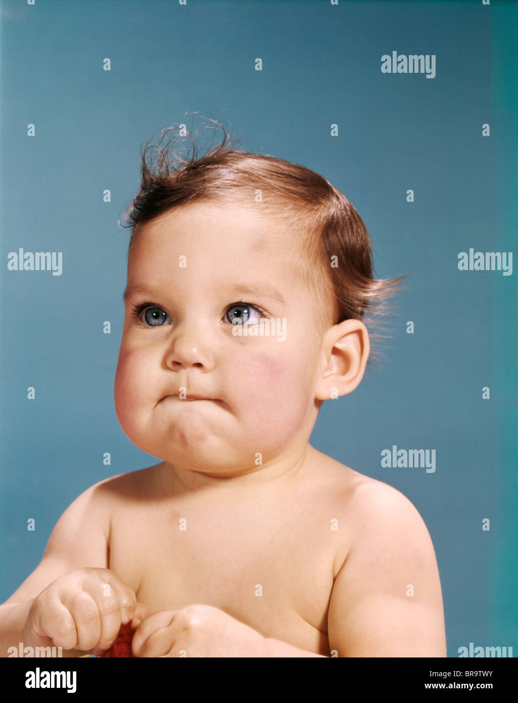 1960s BABY PORTRAIT SERIOUS FACIAL EXPRESSION Stock Photo