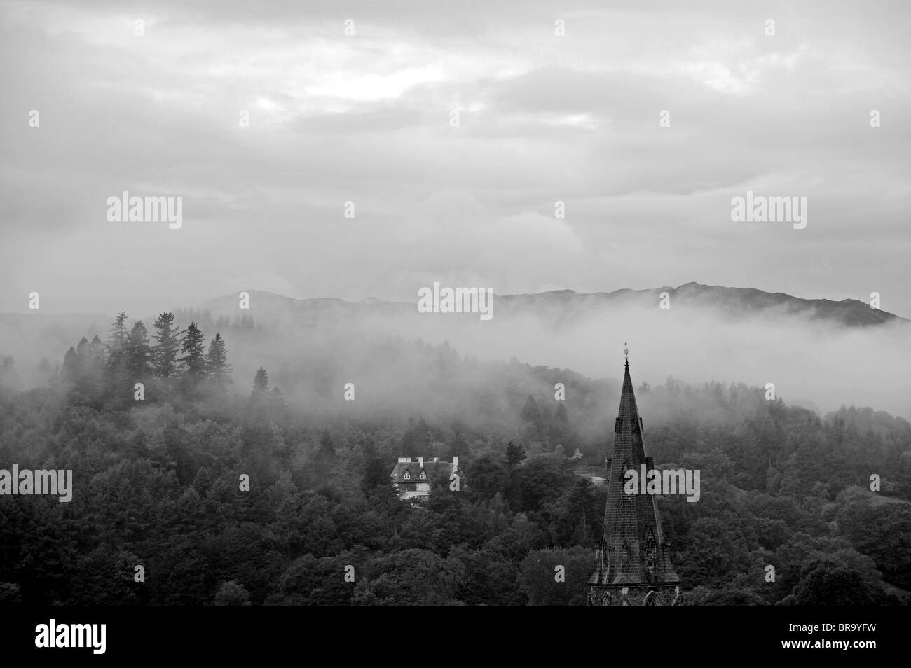 Misty morning over Ambleside with Loughrigg Fell behind in The Lake District Cumbria UK Stock Photo