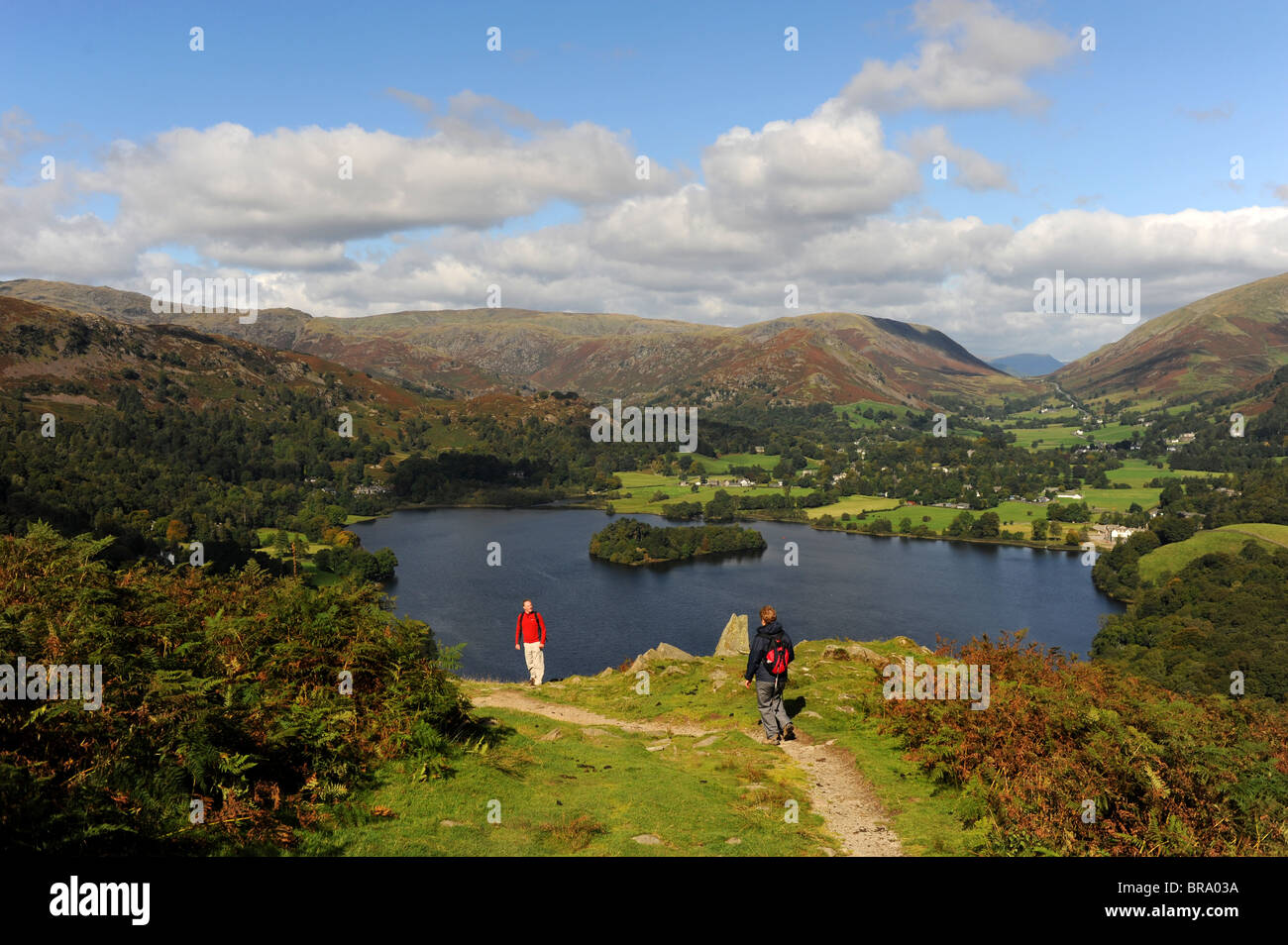 Walkers on Loughrigg Fell overlooking Grasmere near the Lake District village of Ambleside Cumbria UK Stock Photo