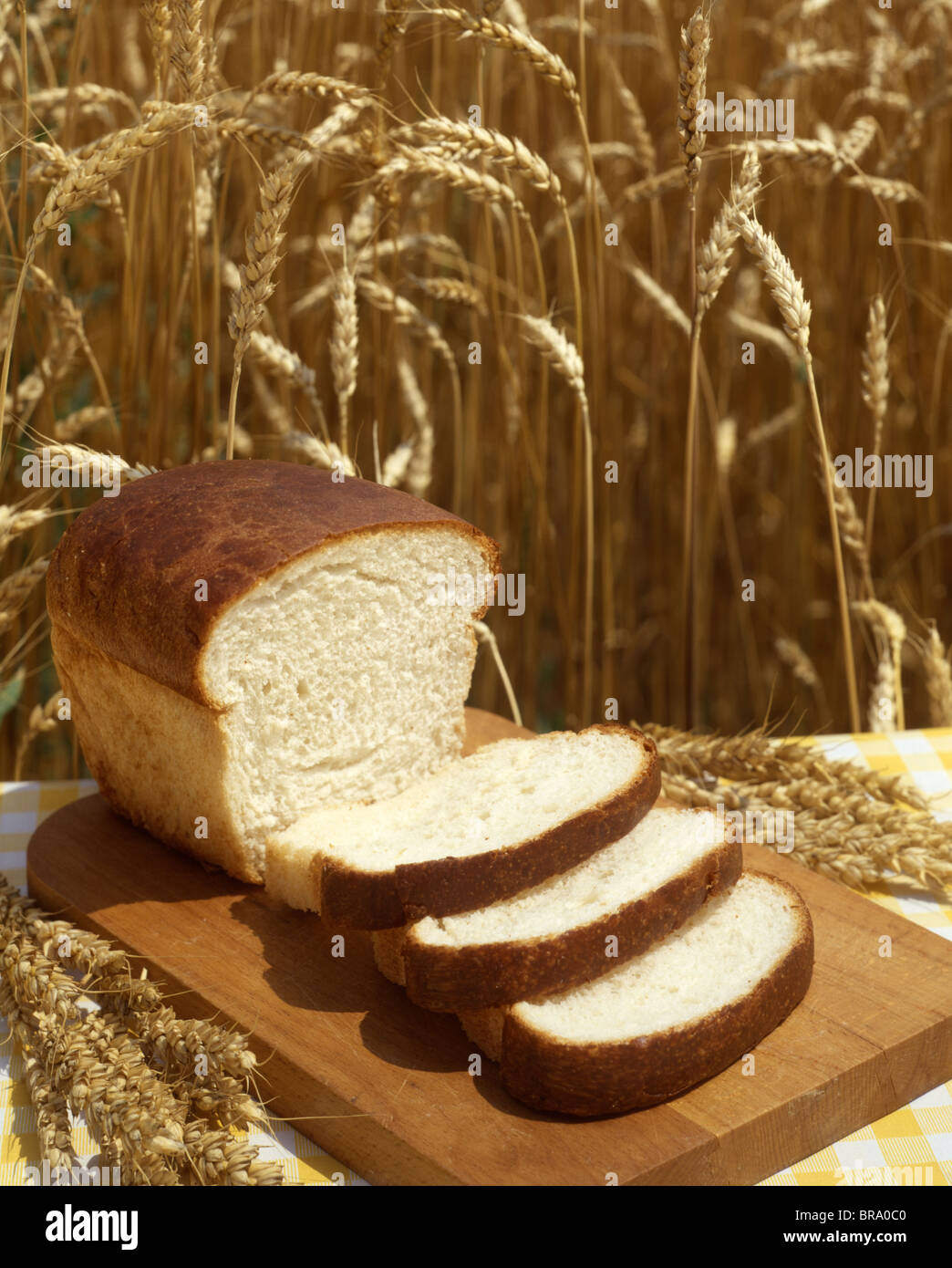 1980s LOAF OF SLICED BREAD HARVEST WHEAT BACKGROUND Stock Photo