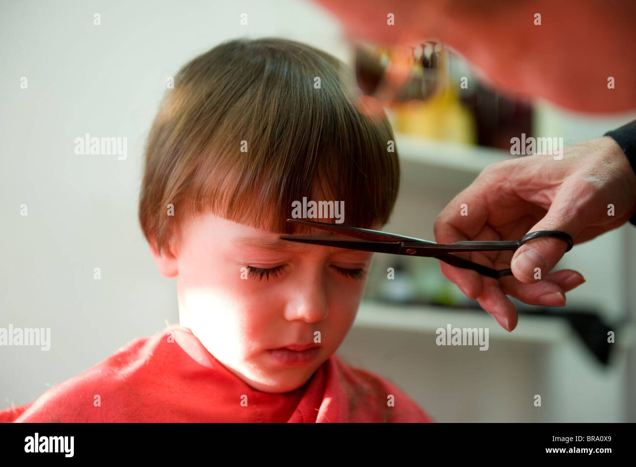 5 Year Old Having A Haircut In A Barbers Salon In North Yorkshire