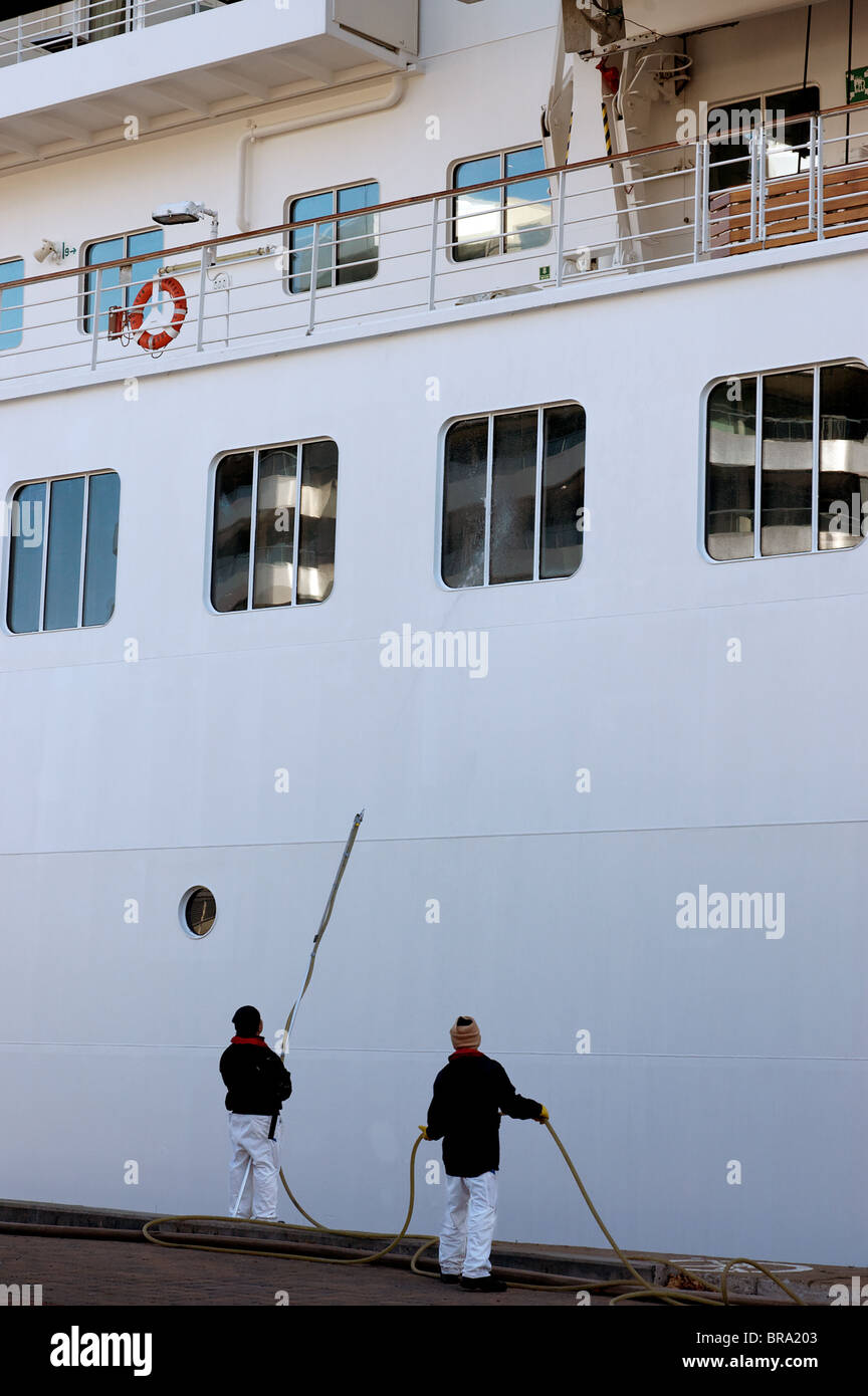 Two men cleaning the outside of a cruise ship Stock Photo Alamy