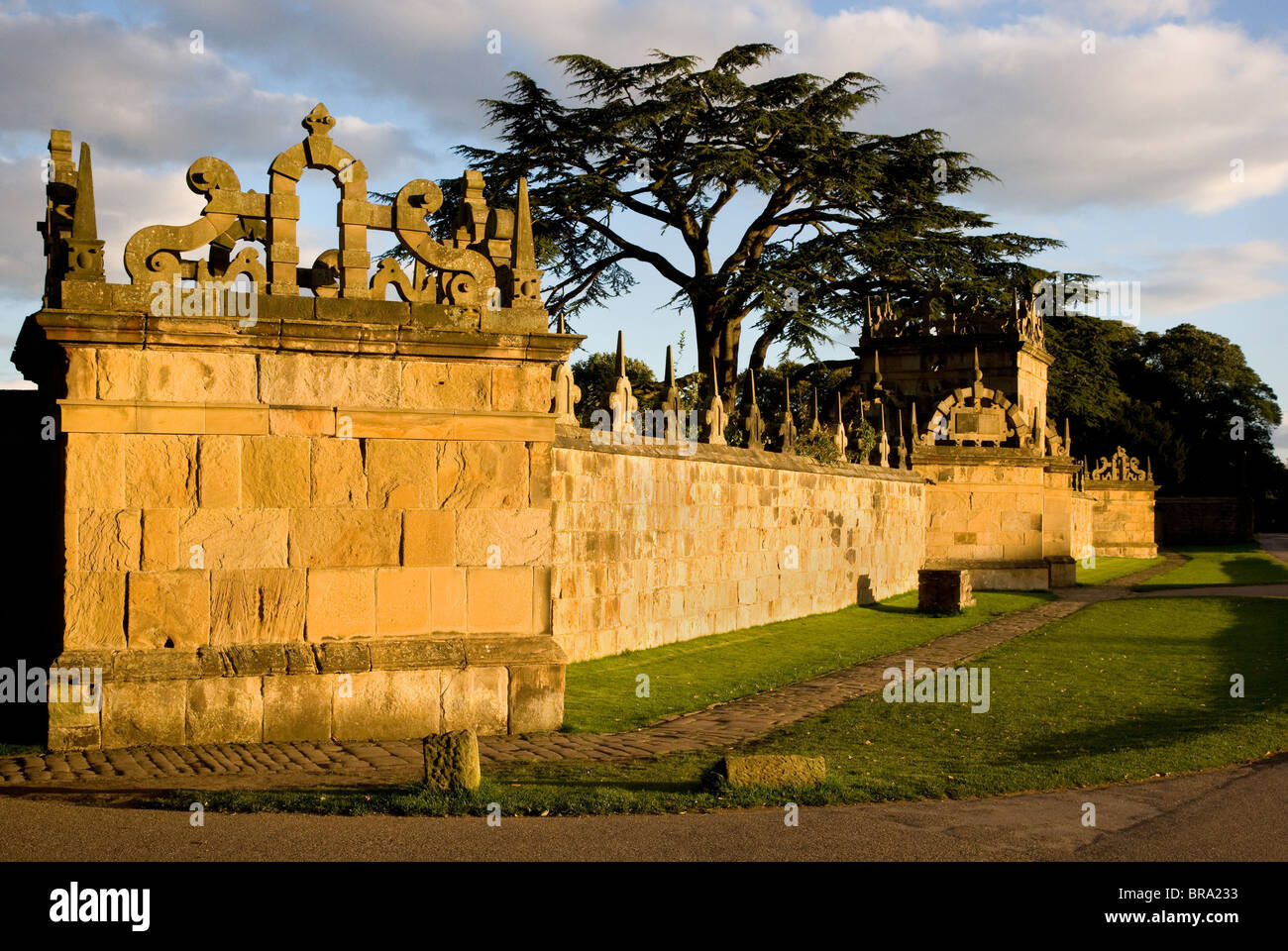 Evening sunlight casts a golden glow on the Magnesian limestone of the outer walls of Hardwick Hall in Derbyshire Stock Photo