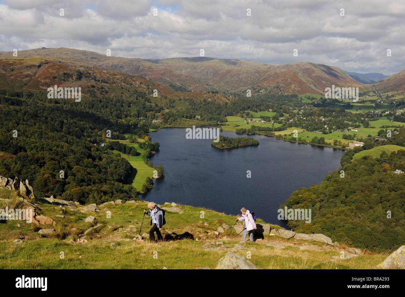 Walkers on Loughrigg Fell overlooking Grasmere near the Lake District village of Ambleside Cumbria UK Stock Photo