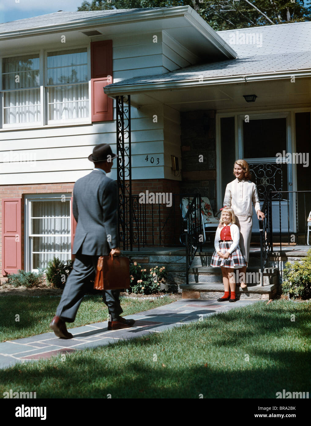 1950s Mother Daughter Waiting Step Suburban House Father Briefcase Coming Home Man Woman Girl Family Retro Stock Photo Alamy