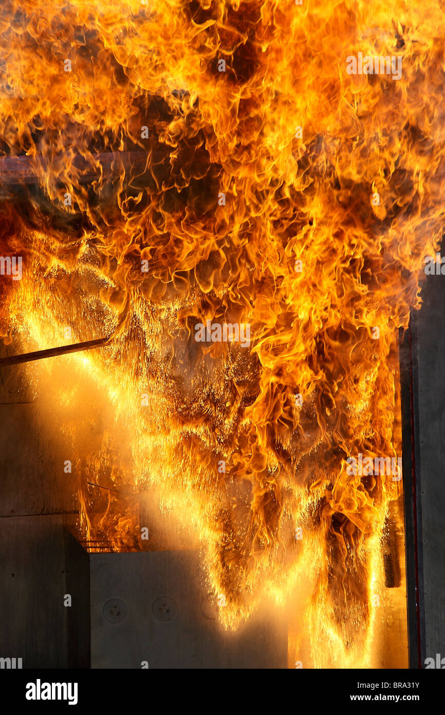 Water onto burning oil fire Stock Photo