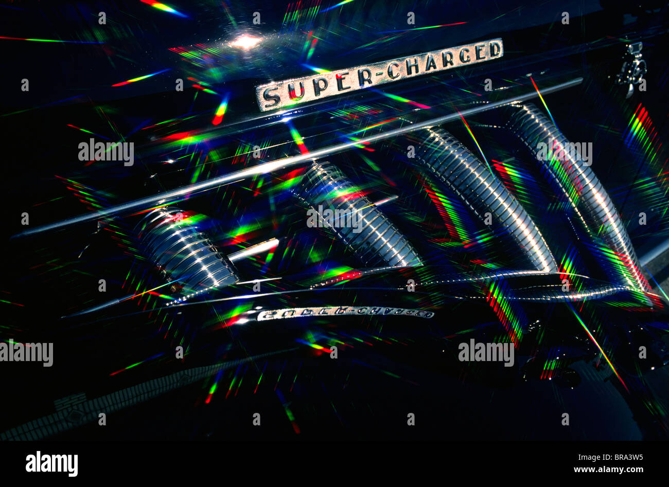 1930s 1930 RETRO SUPER CHARGED MANIFOLD PRISMATIC GRAPHIC EFFECT REFRACTED LIGHT COLORFUL SPEED METALLIC Stock Photo