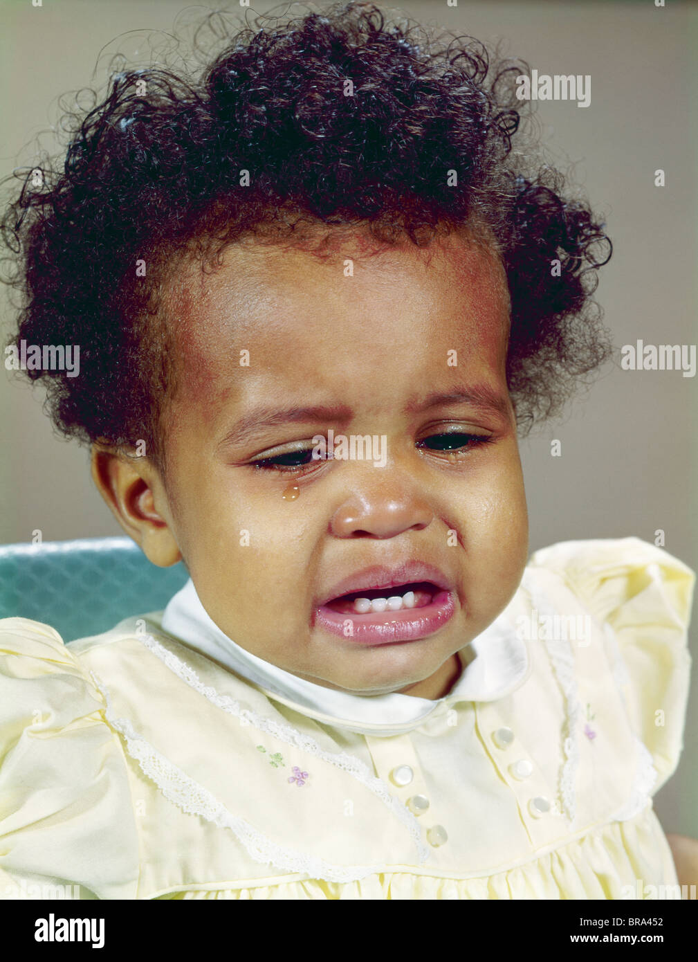 1960s AFRICAN-AMERICAN BABY GIRL CRYING Stock Photo