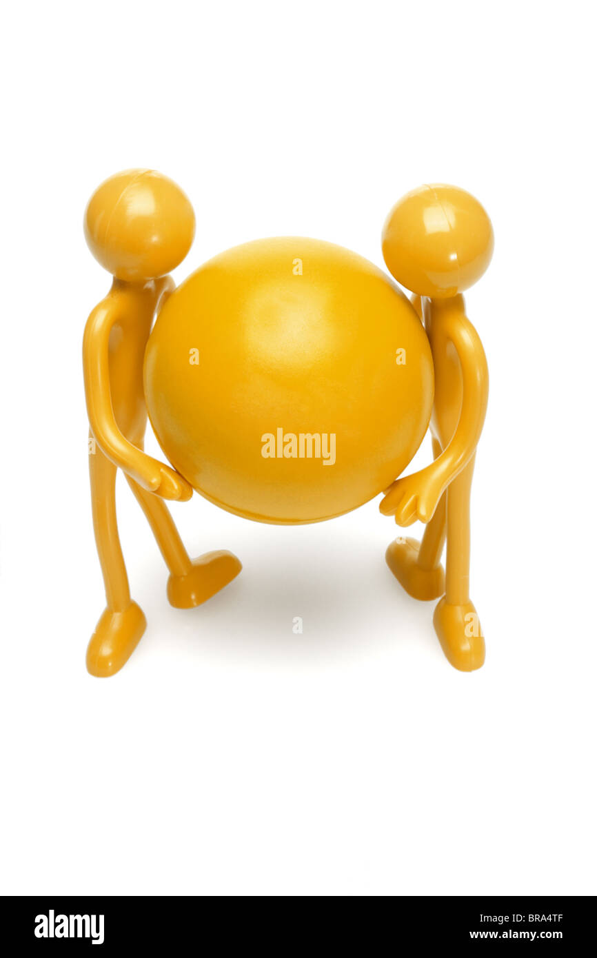Rubber toy figurines holding large ball on white background Stock Photo