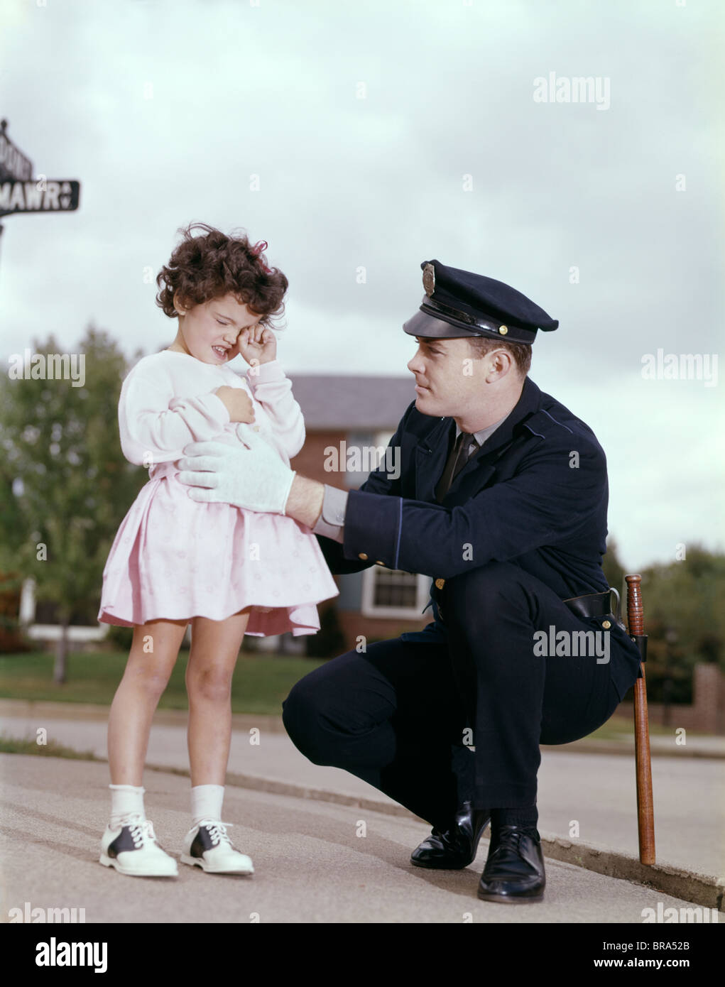 1960 1960s RETRO POLICE OFFICER GIRL LOST CRYING Stock Photo