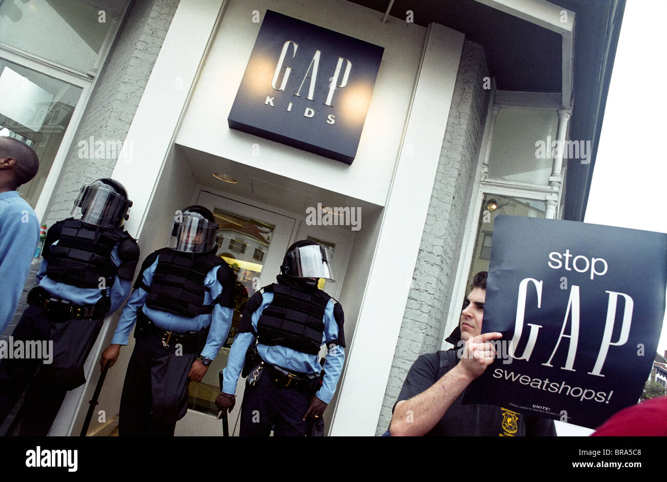 Police in full riot gear and batons guard Gap stores during anti-sweatshop protests in Washington, DC. Stock Photo