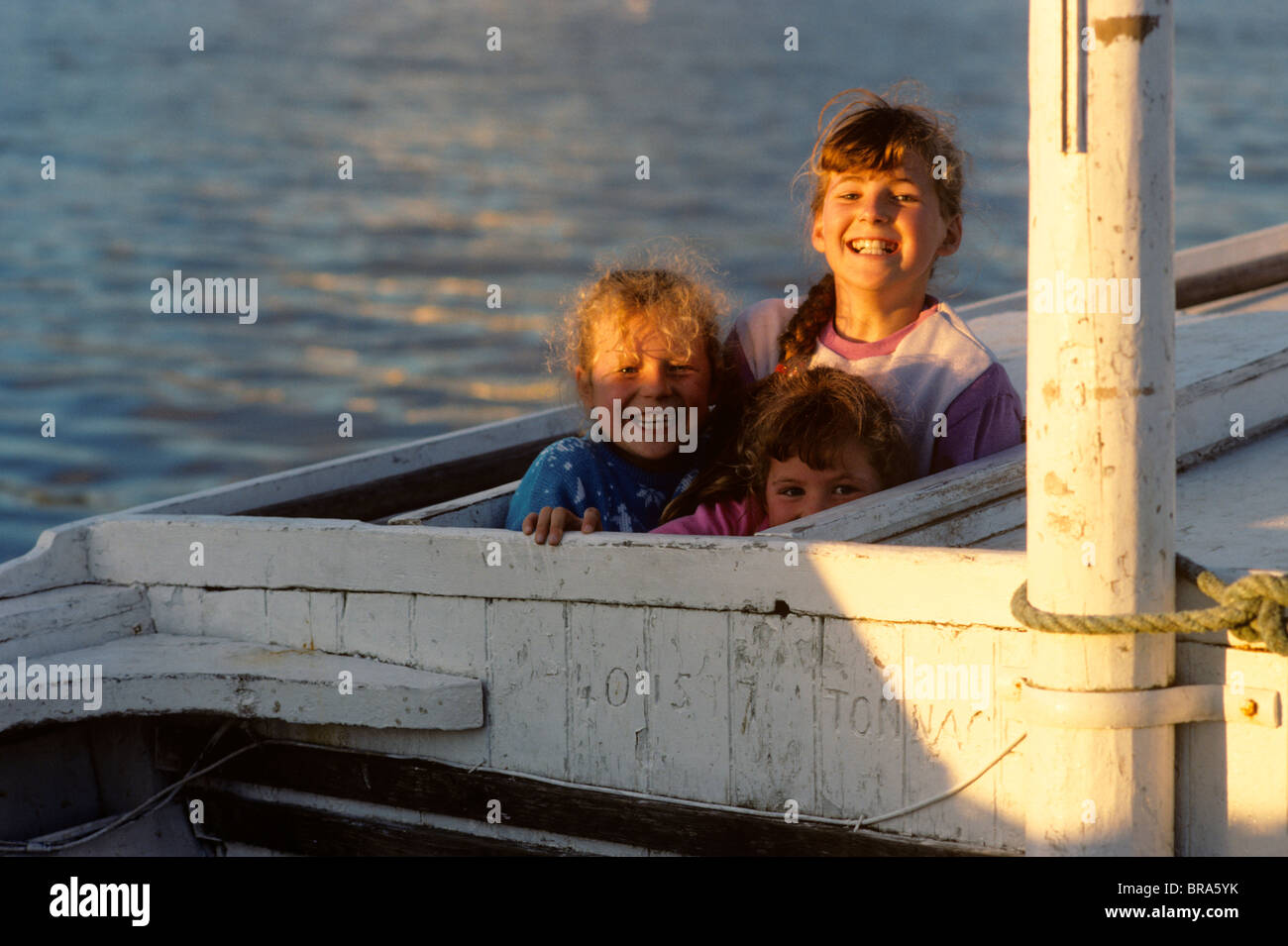1990 1990s RETRO THREE SMILING GIRLS FISHING BOAT COUNTY DONEGAL IRELAND Stock Photo