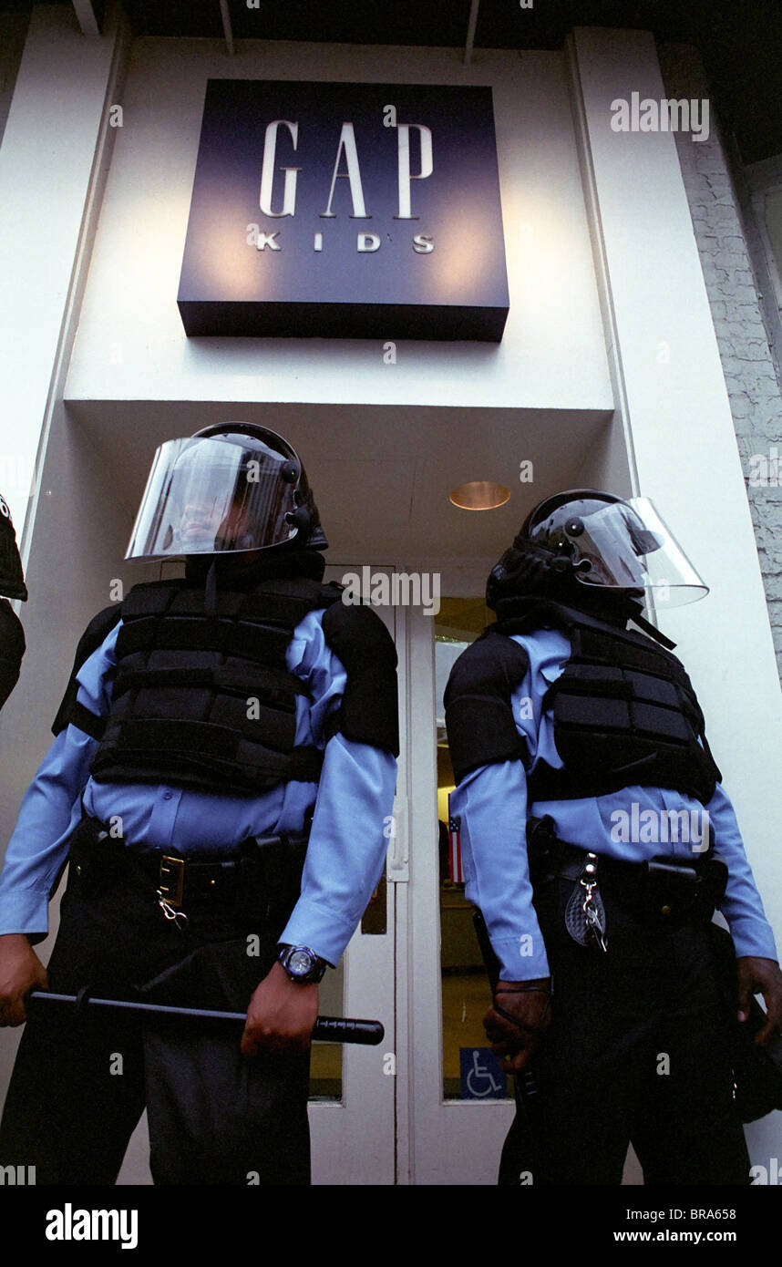 Police in full riot gear and batons guard Gap stores during anti