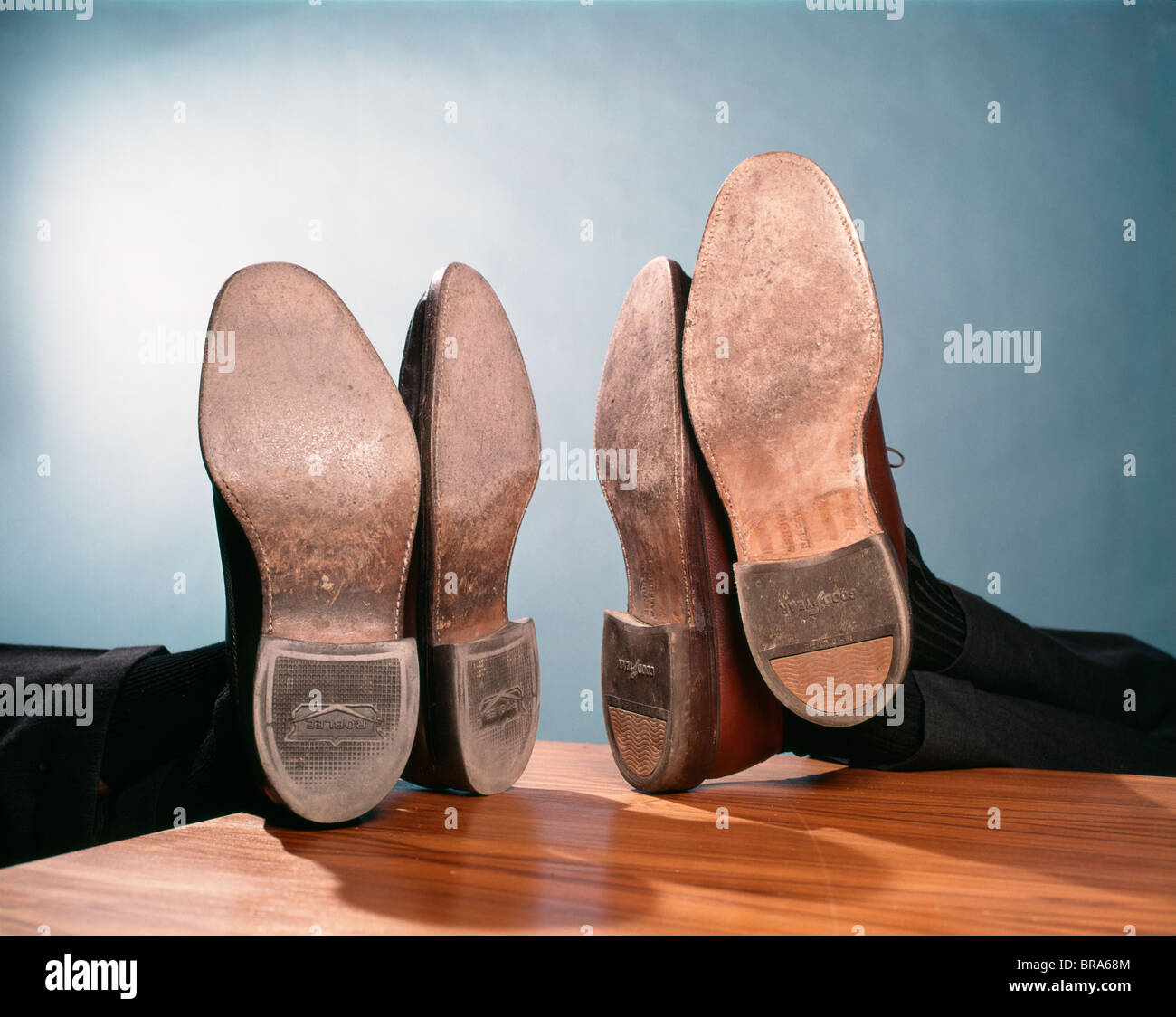 1960s TWO PAIRS OF FEET UP ON DESK SOLES HEELS MEN MALE