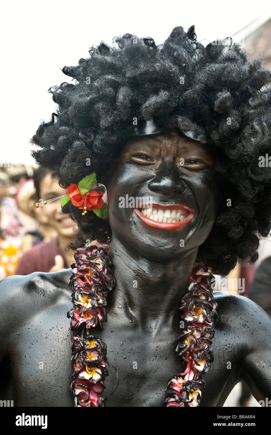 Lao P.D.R., Laos, Luang Prabang, Lao New Year festival, young man wearing wig and painted black Stock Photo