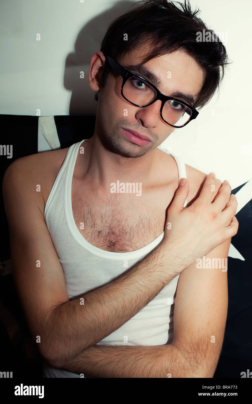 portrait of a young brunette guy in stylish glasses and a white T-shirt  Stock Photo - Alamy, image size:866x1390
