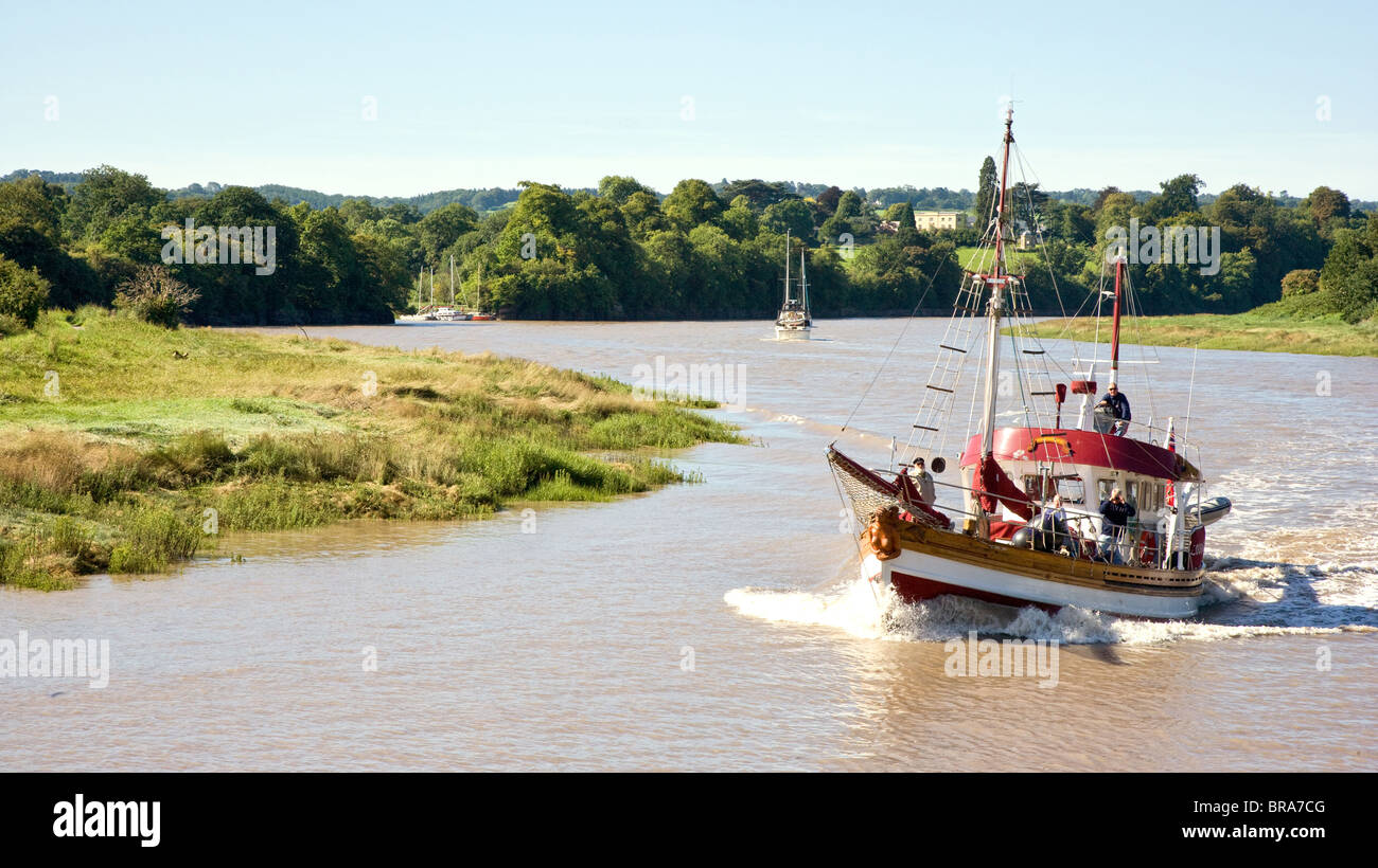 Power boat Courageous II sailing towards Bristol along the sinuous River Avon at Pill at high tide Stock Photo