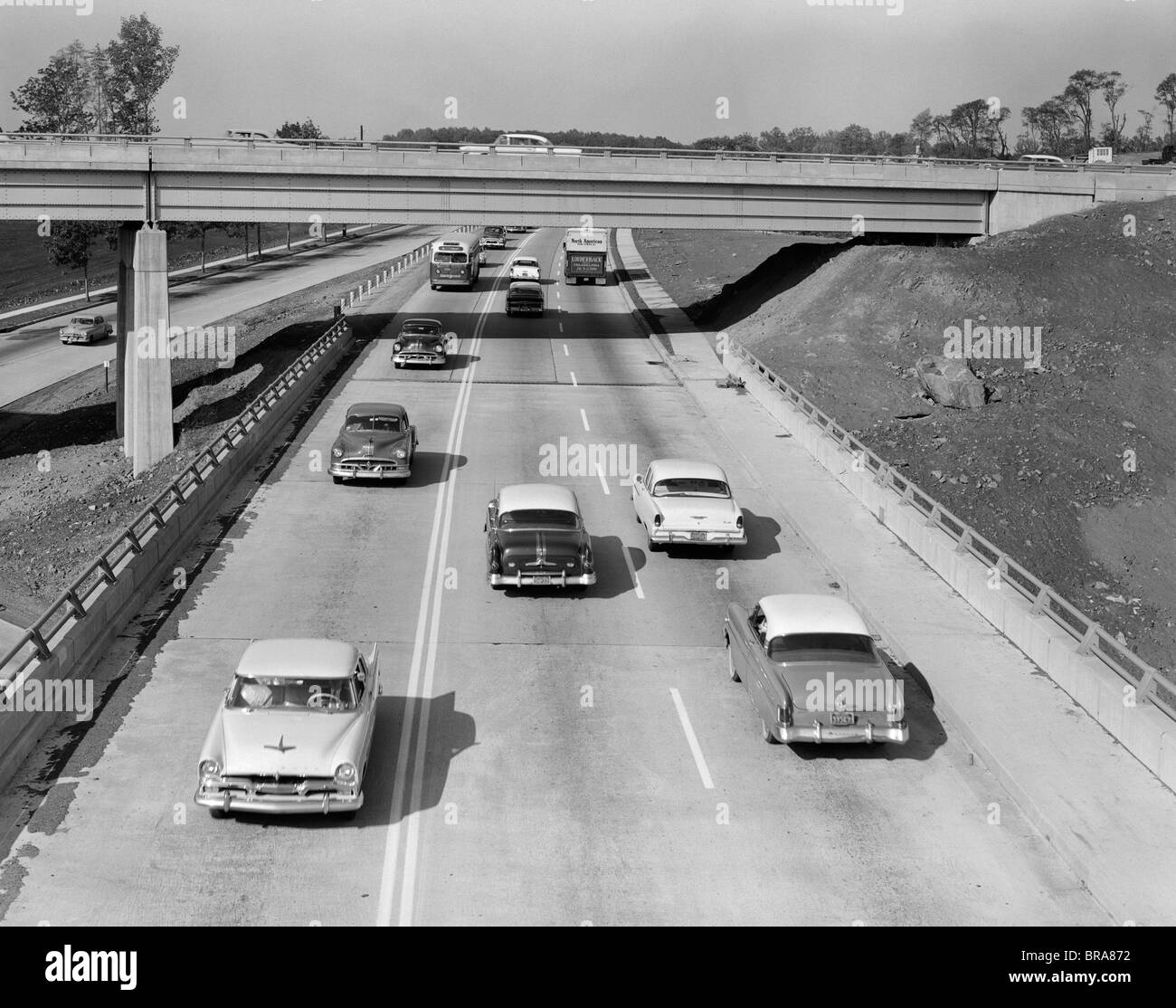 1950s CARS AUTOMOBILES DRIVING ON ROAD Stock Photo