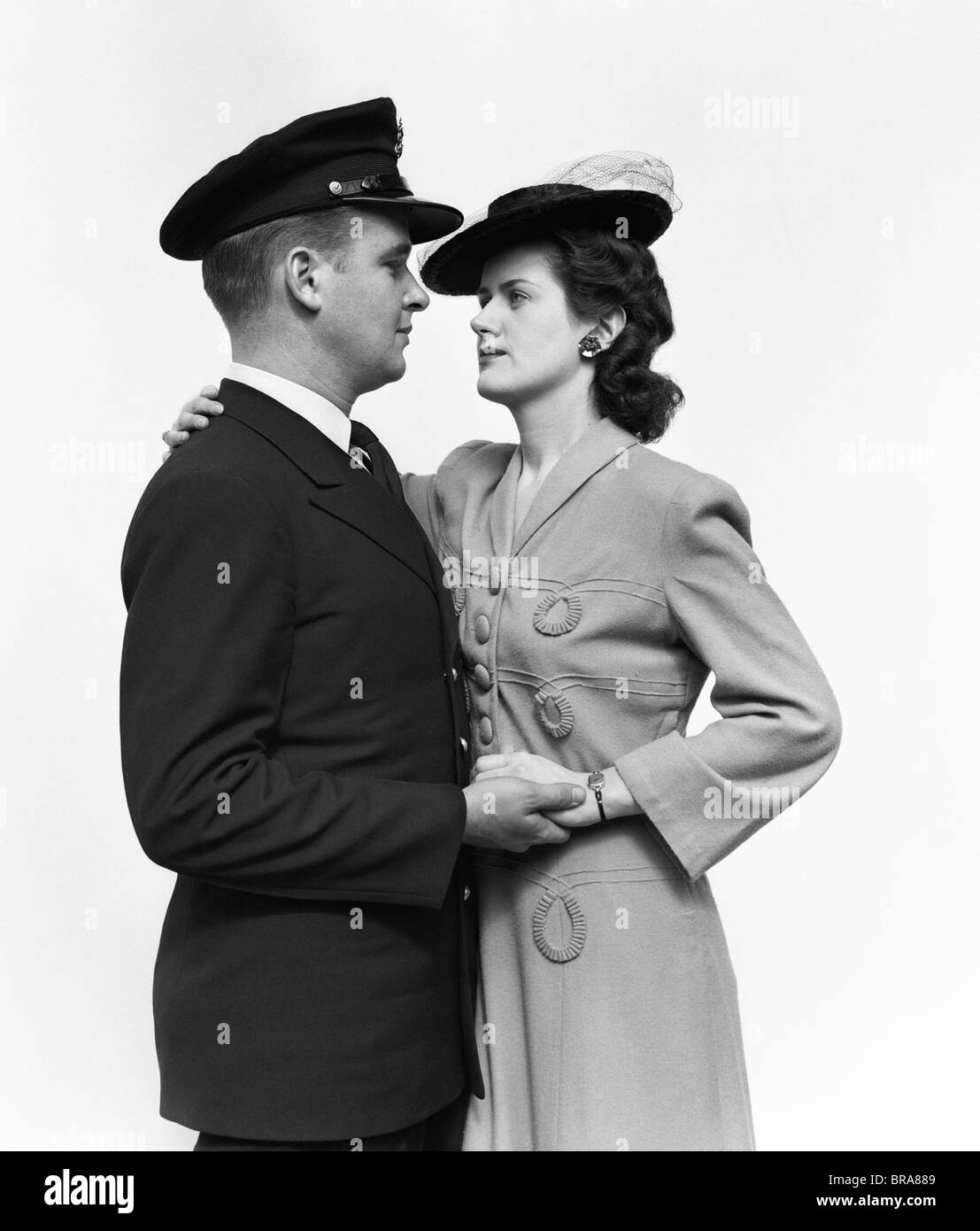 1940s MILITARY COUPLE MAN WOMAN EMBRACING AND HOLDING HANDS Stock Photo